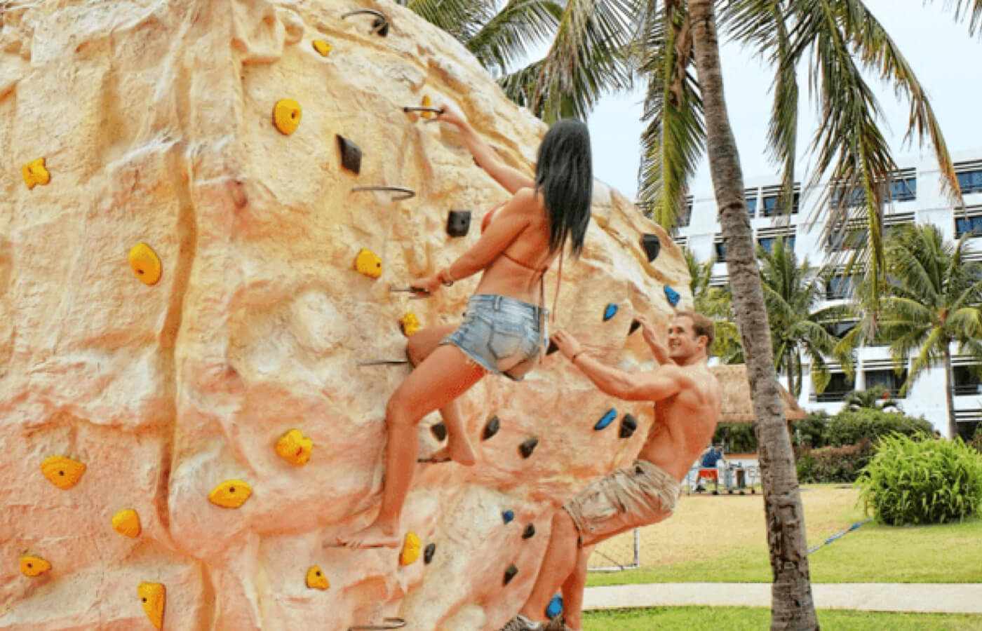 Couple climbing on wall at The Pyramid at Grand Cancun