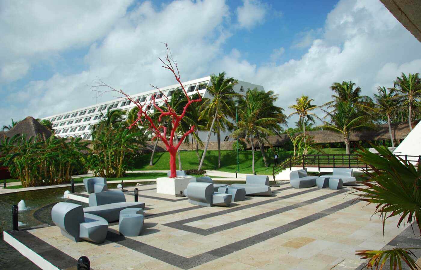 Area with benches and tables in hotel The Pyramid at Grand Oasis