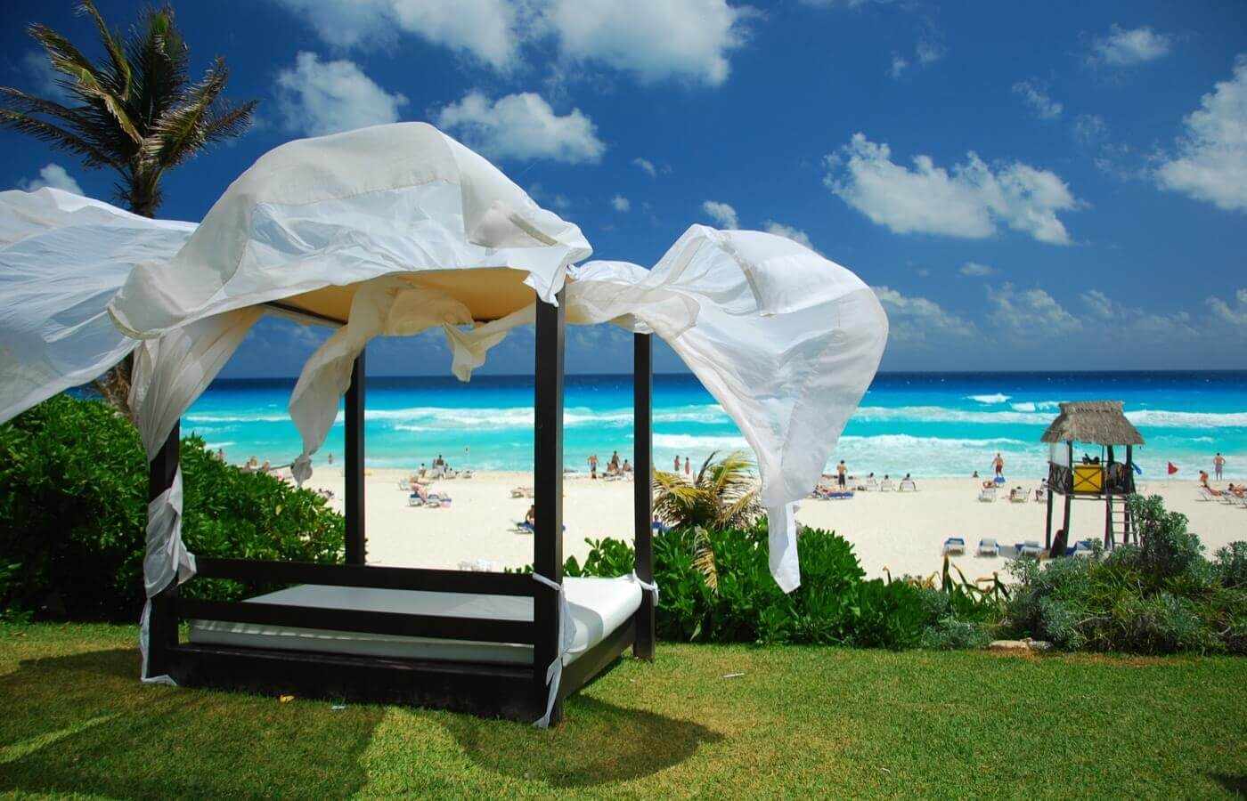 Roofed beach bed with ocean view at The Pyramid at Grand Oasis hotel