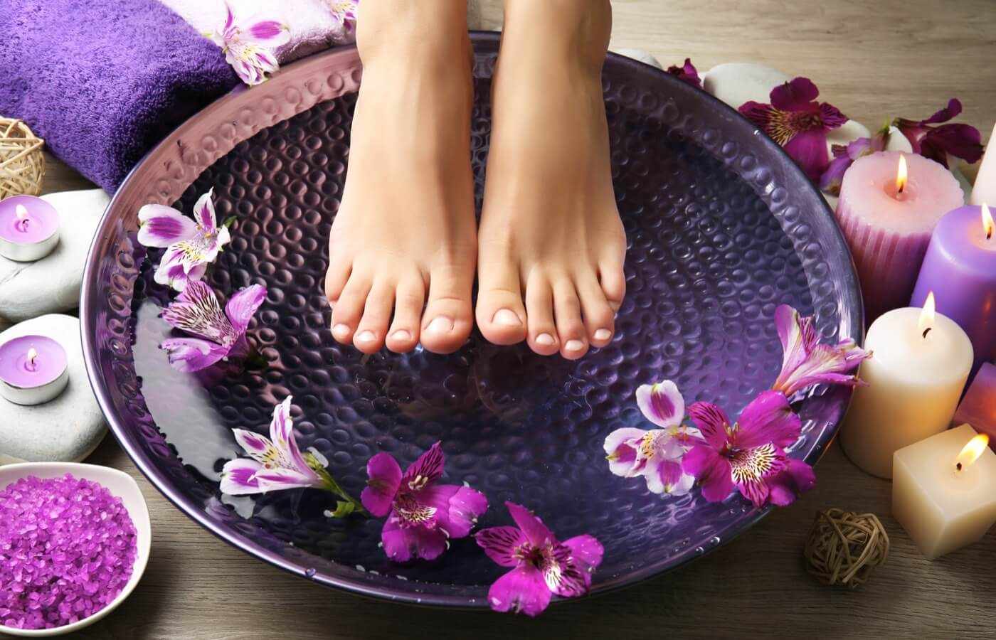 Woman enjoying relaxing massage with hot stones in Hotel The Pyramid at Grand Oasis