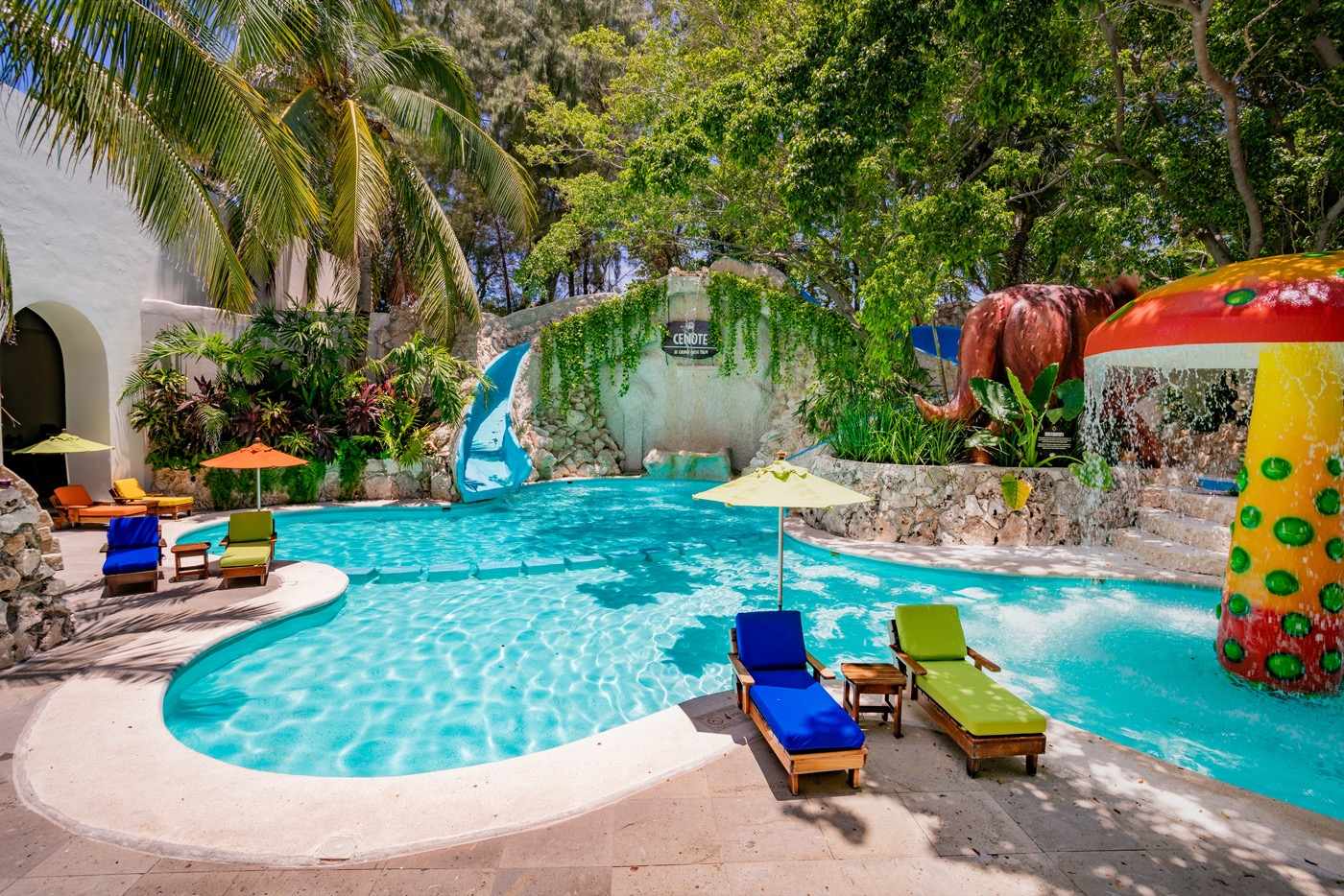 Beds under palm trees on the beach at Hotel Grand Oasis Palm