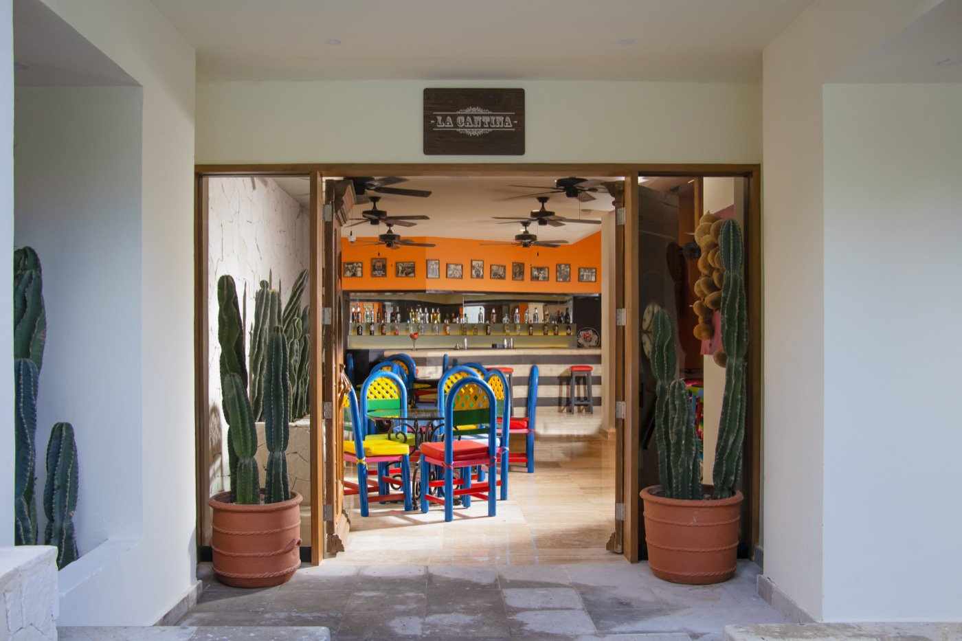 View to the beach with beds and palapas in Oasis hotels